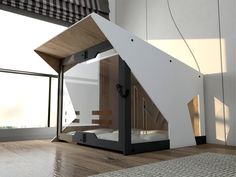 an unusual bed in the middle of a room with wood floors and white walls,