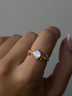 Embrace the beauty of nature and the moon with the Lunar Blossom Ring. Crafted from rose gold-plated sterling silver, this delicate piece features a luminous moonstone set among vine-like details. A perfect blend of elegance and whimsy, this ring is a must-have for any jewelry collection Dainty Rose Gold Opal Jewelry, Delicate Rose Gold Opal Jewelry, Dainty Moonstone Ring With Rose Cut Diamonds, Delicate 14k Rose Gold Jewelry, Ethereal Moonstone Jewelry With Rose Cut Diamonds, Ethereal Jewelry With Rose Cut Diamonds And Moonstone, Dainty Rose Gold Moonstone Jewelry, Delicate Oval Rose Gold Jewelry, Dainty Moonstone Promise Ring