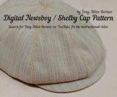 a hat that is sitting on top of a table next to the words digital newsboy / shelby cap pattern