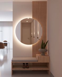 there is a round mirror on the wall above a bench in front of a dining room table