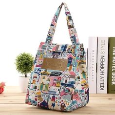 a multicolored bag sitting on top of a wooden table next to some books