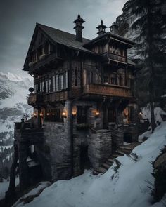 an old wooden house in the mountains with snow on the ground