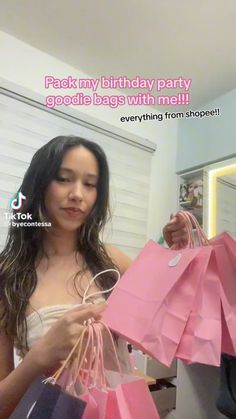 a woman holding pink shopping bags in her hand and the caption reads, back my birthday party goods bags with me