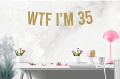 a white desk topped with pink flowers next to a sign that says wft'm 40