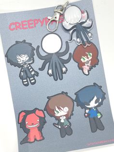 an assortment of cartoon character keychains on a white surface with the word creepy written in red