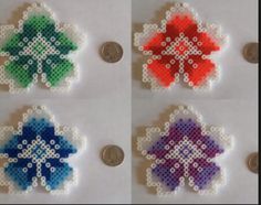 four pieces of perler bead art, each with different colors and designs on them