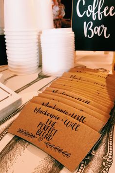 coffee bar business cards sitting on top of a table next to white plates and cups