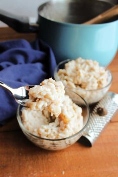 two bowls filled with rice on top of a wooden table