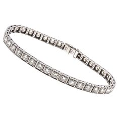 Platinum line bracelet. This marvelous vintage platinum diamond line bracelet features round faceted, European cut diamonds, approximately 3.72 TCW, ranging in clarity from VS2 to Si2, and are J to K color. The stones are prong set into square milgrain edged links, and the bracelet has a hidden box clasp, with a fold over safety clasp. Marks: Irid/Plat Dimensions: 7 1/16" long x 3/16" wide Weight: 8.8 gross dwt Vintage White Gold Diamond Bracelet With Brilliant Cut, Vintage Diamond Tennis Bracelet With Single Cut Diamonds, Timeless Platinum Diamond Bracelet With Accents, Platinum Diamond Bracelet With Single Cut Diamonds, Vintage White Gold Tennis Bracelet With Diamond Accents, Vintage Formal Tennis Bracelet With Single Cut Diamonds, Platinum Diamond Bracelet With Round Cut Accents, Classic Platinum Diamond Bracelet With Single Cut Diamonds, Vintage Round Brilliant Cut Diamond Bracelet