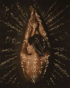 a woman with white paint on her body in the middle of stars and sparkles