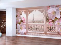 an empty room with pink flowers and the eiffel tower in the background