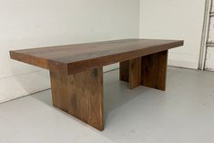 a wooden table sitting on top of a white floor