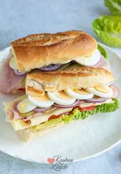 a sandwich with ham, egg and lettuce on a plate