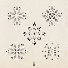 four black and white snowflakes are shown on a piece of paper with ink