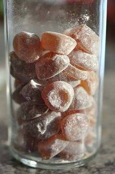 a glass jar filled with candies on top of a table