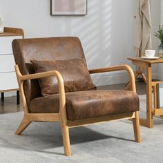 a brown leather chair sitting on top of a carpeted floor next to a table