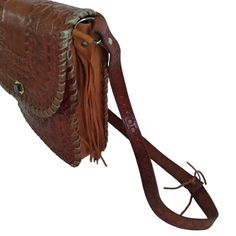 "Hand tooled bag with side tassels and shoulder strap 9 1/2\" x 9\" x 2 3/4\" deep This is a stiff leather cross body bag Great for work or travel Great condition! Like new!!" Vintage Brown Hand-tooled Crossbody Shoulder Bag, Vintage Brown Hand Tooled Crossbody Shoulder Bag, Brown Hand-tooled Crossbody Shoulder Bag, Brown Hand Tooled Crossbody Shoulder Bag, Hand-tooled Brown Crossbody Satchel, Hand Tooled Brown Leather Saddle Bag, Tooled Leather Bag, Leather Saddle Bags, Hand Tooled Leather