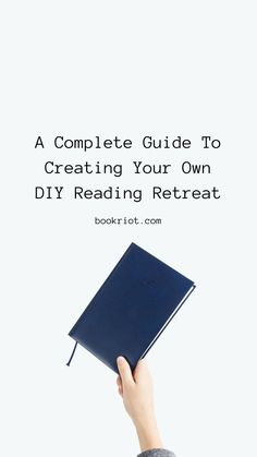 a hand holding a book with the title, a complete guide to creating your own diy reading retreat