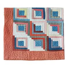 an orange and blue quilt with squares on it