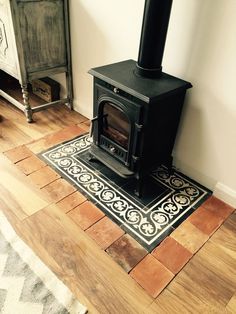 a wood stove sitting on top of a hard wood floor