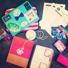 an assortment of school supplies are laid out on the floor next to some books and papers