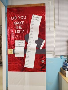 a bulletin board that has been taped to the door with red foil and white paper