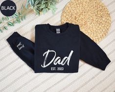 Custom Dad Est with Kids Names Sweatshirt, Personalized Dad Hoodie, Gift for Dad, Fathers Day Gift Idea for Husband, Custom Daddy Sweater Welcome to Custom Fashion Tees! Size & Colors; For  size and color options,  please look at listing images. Gildan Brand, 50% cotton, medium weight and soft touch. Usually runs true size.  DTF printing method is used for these sweatshirts. 𝗛𝗢𝗪 𝗧𝗢 𝗢𝗥𝗗𝗘𝗥: 𝟏. Please, check and review listing photos. 𝟐. Select Your Sweatshirt or Hoodie size and color from drop down menus. 3. Choose Your Quantity you want. 𝟒. Click 𝗔𝗗𝗗 𝗧𝗢 𝗖𝗔𝗥𝗧. Go to your card and finish your order. CARE INSTRUCTIONS: Turn the sweatshirt or hoodie inside out. Machine wash cold with mild detergent. Tumble dry very low. Do not use bleach. Do not iron directly on design. RE Gift Idea For Husband, Kids Names, Dtf Printing, Gift For Dad, Kid Names, Fashion Tees, Medium Weight, Fathers Day Gifts, Gifts For Dad