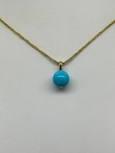 Sleeping Beauty Turquoise Bead Pendant.  This hand made pendant features a Robins Egg Blue Sleeping Beauty Turquoise Bead Round Polished 10mm mounted on a 14K yellow gold solid bail 3 X 4.2mm I.D. The pendant measures 11/16 inch.  The Turquoise Bead is Genuine and Natural in color, no dyes, it has been stabilized to protect its color.  This pretty minimalist pendant can be worn alone or layered with your favorite pieces.  The pendant pictured is the one you will receive.  NO CHAIN IS INCLUDED.  It will arrive in a nice presentation box with a Certificate of Authenticity.   Please visit our Shop for more Pearls and Gemstone Jewelry. Elegant Turquoise Necklace With Round Blue Pendant, Elegant Turquoise Necklace With Polished Beads, Elegant Turquoise Necklace With Polished Beads As Gift, Elegant Blue Turquoise Necklace With Round Pendant, Elegant Turquoise Necklace With Polished Beads For Gift, Elegant Blue Turquoise Round Pendant Necklace, Yellow Gold Turquoise Necklace With Round Beads As Gift, Elegant Yellow Gold Turquoise Necklace With Cabochon, Elegant Yellow Gold Turquoise Cabochon Necklace