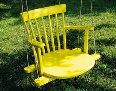 a yellow chair sitting on top of a lush green field next to a tree and text that reads, got a broken chair? turn it into a swing see more