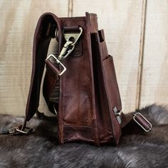 This bag is designed to hold all of your D&D gear! ~Made from 100% full-grain goat leather, lined with canvas fabric. ~Ethically sourced leather! ~Traditional brass buckles or snap-locks for convenient opening and closing ~No leather upkeep is necessary! ~Weather Resistant! Coated with a vegetable oil tan to protect against weather climates ~Includes adjustable strap and extra hooks on back for re-positioning Measurements (in inches): Width/Height/Depth: 9in. x 12in. x5in. 1 Full size back zippe Leather Saddle Bag With Adjustable Strap For Outdoor, Saddle Bags With Palladium Hardware For Everyday Use, Rectangular Leather Satchel For Outdoor, Top Handle Satchel With Brass Hardware For Travel, Outdoor Leather Shoulder Saddle Bag, Outdoor Rectangular Leather Satchel, Rectangular Leather Shoulder Bag For Outdoor, Rugged Bag With Adjustable Strap For Everyday Use, Leather Saddle Shoulder Bag With Palladium Hardware