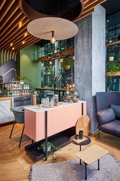 a living room filled with furniture next to a window covered in glass and wood beams