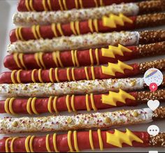 several different types of hot dogs on sticks with sprinkles