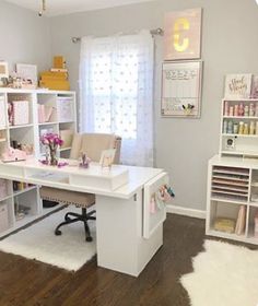 a white desk sitting inside of a room next to a book shelf filled with lots of books