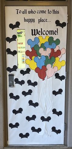 a door decorated with mickey mouse balloons and the words, to all who come to this happy place welcome