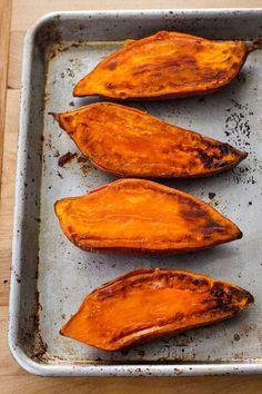 baked sweet potatoes on a baking sheet ready to be cooked in the oven for dinner