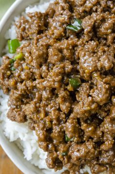 a white bowl filled with meat and rice