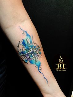 a person with a compass tattoo on their arm