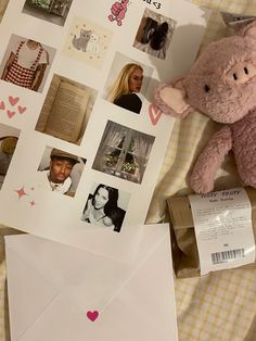 a pink teddy bear sitting on top of a bed next to envelopes and photos