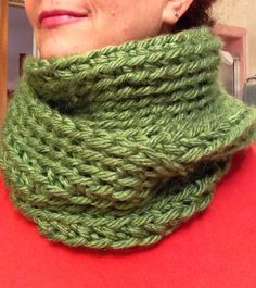 a woman wearing a green knitted cowl