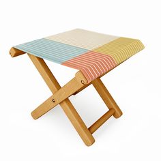 a multicolored striped wooden stool on a white background