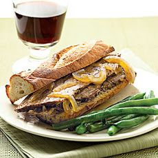 a sandwich and some green beans on a plate