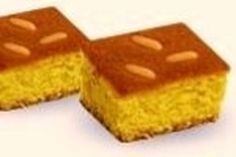 two pieces of yellow cake sitting on top of each other in the shape of squares