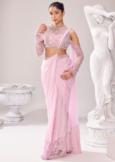 Our beguiling semi ethnic saree makes a dreamy walk at any occasion. Encapsulate the detailed embellishments in this rhythmic silhouettes that translate to everyday poetry. Pearl is a significant element of this collection and so with other elements, highlights the sleeves and border of the saree. The blouse has a halter neck with cold shoulder sleeves. The ring goes in the center highlighting the drape of the saree. Elegant Designer Pre-draped Saree With Resham Embroidery, Transitional Bollywood Style Embellished Pre-draped Saree, Elegant Pre-draped Saree, Elegant Georgette Saree For Transitional Season, Elegant Pre-draped Saree With Resham Embroidery For Transitional Season, Elegant Pre-draped Saree With Unstitched Blouse For Transitional Season, Festive Fusion Pre-draped Saree With Unstitched Blouse, Elegant Pre-draped Saree For Transitional Season, Transitional Pre-draped Elegant Saree