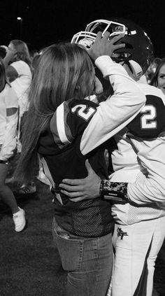 the football players are hugging each other on the field