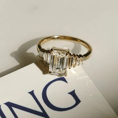 an engagement ring sitting on top of a box