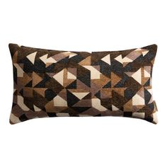 a brown and black pillow with geometric shapes on the front, sitting on a white background