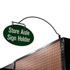 there is a sign that says store aisle sign holder hanging from the side of a wall