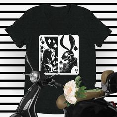 Unleash Your Wild with our Goth Alice-in-Wonderland and White Rabbit T-shirt  From our Fractured Fairy Tales Collection, step into a world of inspiration, nostalgia, and creativity with our Goth Alice-in-Wonderland and White Rabbit tee. Featuring an enchanting design of Alice-in-Wonderland and the white rabbit staring at each other curiously, both the object of playing cards, this unisex tee captures a unique spin on the timeless classic. This tee is part of our exclusive Fractured Fairy Tales Capsule Collection, reinventing timeless stories that celebrate the bond between animal and human.  Perfect Gift for Any Occasion  Spark the imagination of any Goth lover with this soft-style vintage Goth Alice-in-Wonderland tee. Whether you're searching for a goth gift, feminist gift, literary gift Alice In Wonderland Shirt Women, Alice In Wonderland White Rabbit Shirt, Alice And Wonderland Group Shirts, Alice In Wonderland Shirts For Men, Staring At Each Other, Fractured Fairy Tales, The White Rabbit, Vintage Goth, Feminist Gift