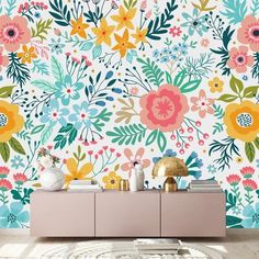 a floral wallpaper with colorful flowers and leaves on the sideboard in a living room