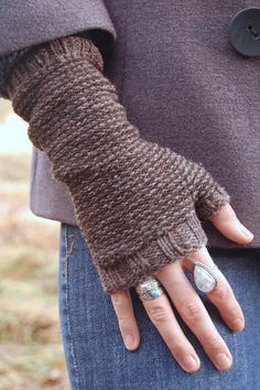 a close up of a person's hands wearing mittens and gloves with buttons on them